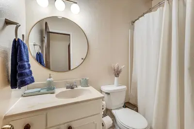a bathroom with a sink and a toilet and a mirror at 4 Mi to State Park Quiet Escape with Deck in Arnold in Arnold