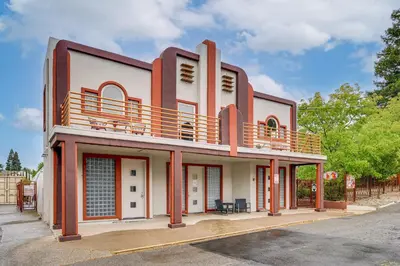 a building with a balcony on top of it at Easily Explore Fair Oaks Village! Unique Condo in Fair Oaks