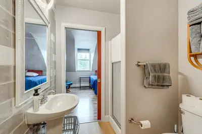 a bathroom with a sink and a mirror at Easily Explore Fair Oaks Village! Unique Condo in Fair Oaks