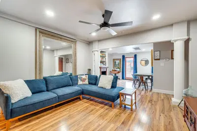 a living room with a blue couch and a ceiling fan at Easily Explore Fair Oaks Village! Unique Condo in Fair Oaks