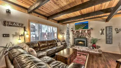 a living room with a leather couch and a fireplace at COH0809 - Brule Haven home in South Lake Tahoe