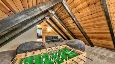 an attic room with a pool table and chairs at COH0809 - Brule Haven home in South Lake Tahoe