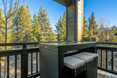 a balcony with a wicker bench and a tower at Mammoth Green #220 - Nearly Ski-In Ski-Out 3 Bedroom 2 Bath, Sleeps 8 in Mammoth Lakes