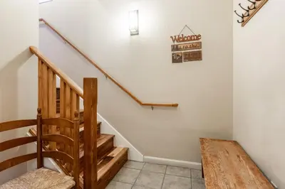 a staircase in a house with a sign on the wall at Mammoth Green #220 - Nearly Ski-In Ski-Out 3 Bedroom 2 Bath, Sleeps 8 in Mammoth Lakes