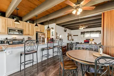 a kitchen and dining room with a table and chairs at Tahoe Keys Studio Condo in South Lake Tahoe