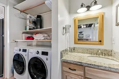 a bathroom with a washing machine and a sink at Tahoe Keys Studio Condo in South Lake Tahoe