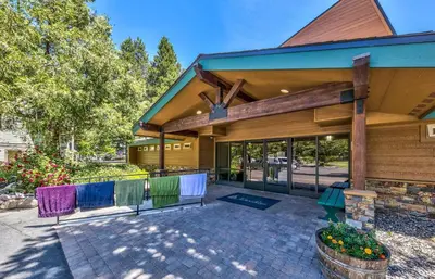 a home with chairs in front of a building at Tahoe Keys Studio Condo in South Lake Tahoe