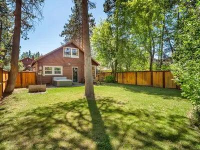 a backyard with a house and a fence at Tahoe Classic Cabin Near the Beach in South Lake Tahoe