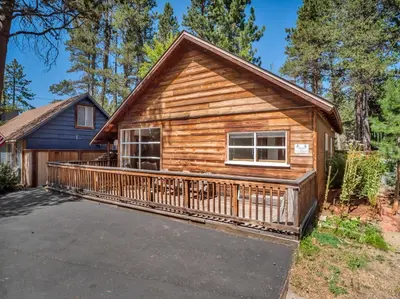 a large log cabin with a large deck at Tahoe Classic Cabin Near the Beach in South Lake Tahoe