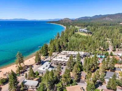 an aerial view of a resort with a beach and water at Tahoe Classic Cabin Near the Beach in South Lake Tahoe
