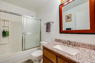 a bathroom with a sink and a toilet and a mirror at Quaking Aspen Condo in Stateline