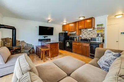 a living room with a couch and a kitchen at Quaking Aspen Condo in Stateline