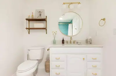 a bathroom with a toilet and a mirror at Huth Street Haven in Lake Isabella