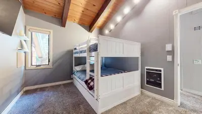 a bedroom with a bunk bed in a room at Chateau Blanc #2 condo in Mammoth Lakes