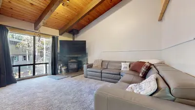 a living room with a couch and a fireplace at Chateau Blanc #2 condo in Mammoth Lakes