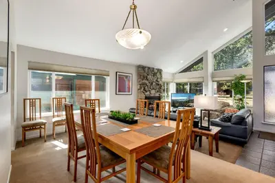 a dining room and living room with a table and chairs at Spacious Riverfront home in South Lake Tahoe