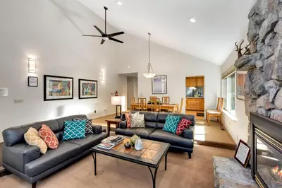 a living room with a couch and a fireplace at Spacious Riverfront home in South Lake Tahoe
