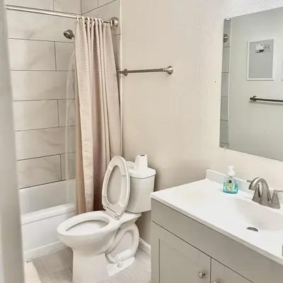 a white bathroom with a toilet and a sink at Near Lake, Golf and Tennis - Reno Condo in Reno