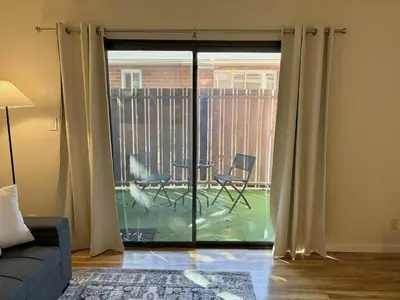 a living room with a sliding glass door to a patio at Near Lake, Golf and Tennis - Reno Condo in Reno