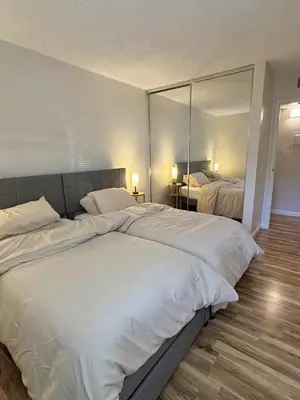 a bedroom with two beds and a large mirror at Near Lake, Golf and Tennis - Reno Condo in Reno