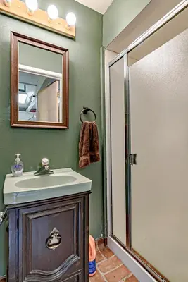 a bathroom with a sink and a mirror and a shower at Lake Tahoe West Shore Lake Front 5 bedroom Cabin in Homewood