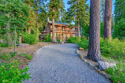 a path leading to a house in the woods at Lake Tahoe West Shore Lake Front 5 bedroom Cabin in Homewood