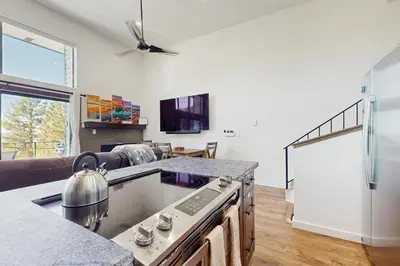 a kitchen with a stove top oven next to a living room at Lakeview Landing in Stateline