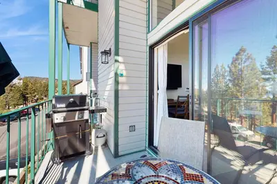 a balcony with a grill and a table on a porch at Lakeview Landing in Stateline