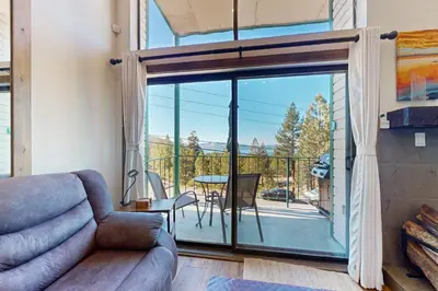 a living room with a couch and a sliding glass door at Lakeview Landing in Stateline