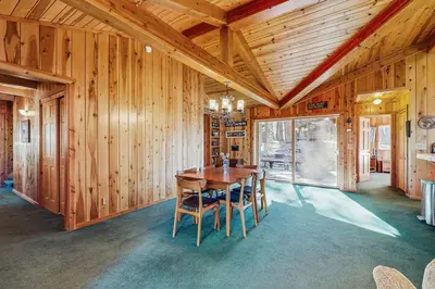 a wooden dining room with a wooden table and chairs at Tahoe Getaway in Homewood