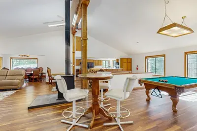 a living room with a pool table at Serene Road Lodge in Soda Springs