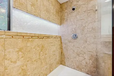 a bathroom with a shower with a glass door at Serene Road Lodge in Soda Springs