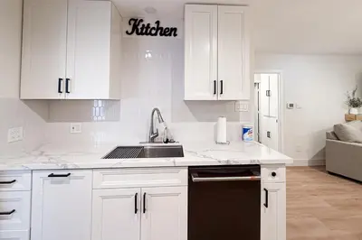 a kitchen with white cabinets and a sink at Sierra Pines Retreat Tahoe in South Lake Tahoe