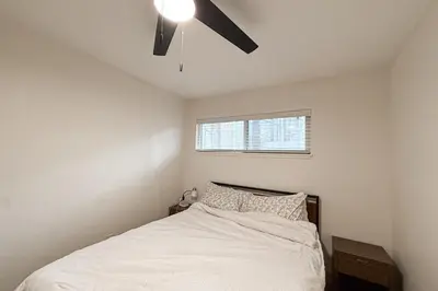 a bedroom with a bed with a ceiling fan at Sierra Pines Retreat Tahoe in South Lake Tahoe