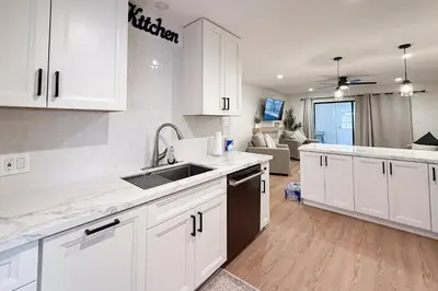 a kitchen with white cabinets and a sink at Sierra Pines Retreat Tahoe in South Lake Tahoe