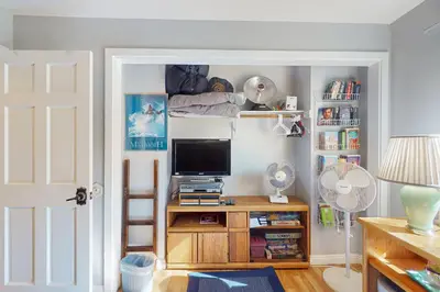 a room with a tv and a book shelf at Chateau Sans Nom 38 in Mammoth Lakes