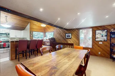 a kitchen and dining room with a wooden table and chairs at Snowcreek 51 in Mammoth Lakes