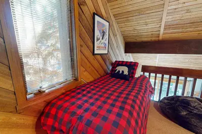 a bedroom with a checkered bed in a cabin at Snowcreek 51 in Mammoth Lakes