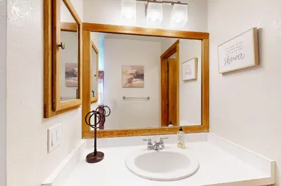 a bathroom with a sink and a large mirror at Snowcreek 51 in Mammoth Lakes