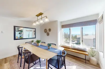 a dining room with a table and chairs and a window at Sierra Megeve 31 in Mammoth Lakes