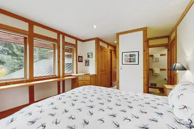 a bedroom with a bed and a window at Bear Creek Pond Chalet in Alpine Meadows