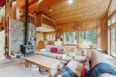 a living room with a couch and a fireplace at Bear Creek Pond Chalet in Alpine Meadows