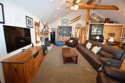 a living room with a couch and a tv at Owens Den- Lake AreaFree Night Special in Bass Lake