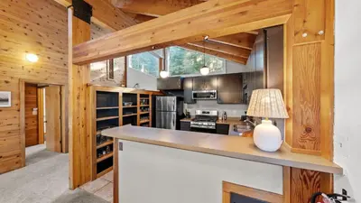 a kitchen with wooden walls and a large counter top at Hot Tub Sauna Forest Views in Tahoe Donner Cedar Summit by Avantstay in Truckee
