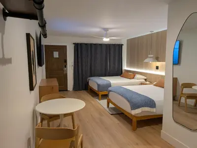 a hotel room with two beds and a table at The Iceberg Tahoe in South Lake Tahoe