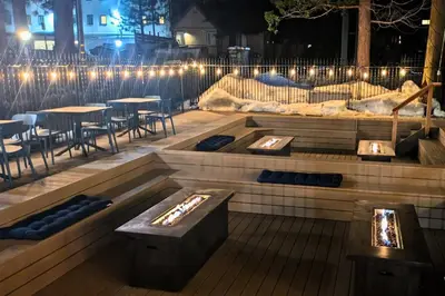 a patio with tables and chairs and lights at night at The Iceberg Tahoe in South Lake Tahoe