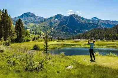 a man flying a kite on a golf course at Remodeled Second Floor Valley View suite in Olympic Valley