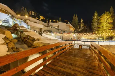 a wooden boardwalk leading to a resort at night at Remodeled Second Floor Valley View suite in Olympic Valley