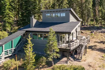 a small house with a black roof at Panoramic Peaks at Alpine by Tahoe Getaways - Pet Friendly, AC, Hot Tub, Shuttle & Stunning Views in Alpine Meadows