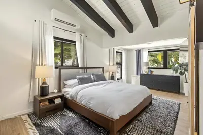a bedroom with a large bed and a large window at Panoramic Peaks at Alpine by Tahoe Getaways - Pet Friendly, AC, Hot Tub, Shuttle & Stunning Views in Alpine Meadows